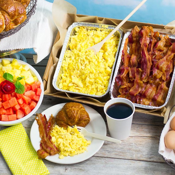 Trays of eggs and bacon alongside coffee, provided by our Hunters Point, Queens corporate breakfast caterers.