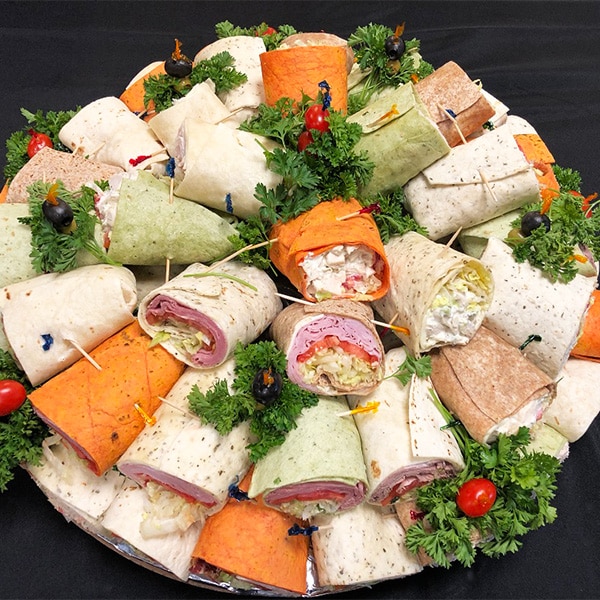 A tray filled with fresh deli sandwich wraps, provided by our Queens short notice caterers.